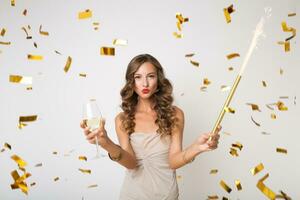 pretty woman celebrating party in golden confetti photo