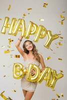 pretty woman celebrating party in golden confetti photo