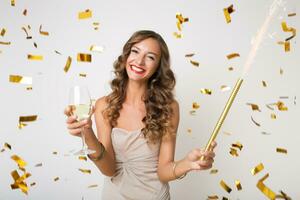 pretty woman celebrating party in golden confetti photo