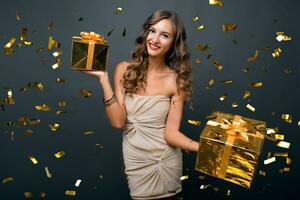 pretty woman celebrating party in golden confetti photo