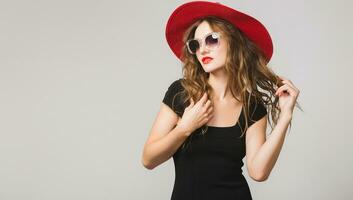 young beautiful stylish woman in black dress, red hat photo