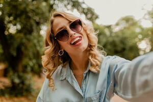 stylish blond woman walking in street park summer fashion photo