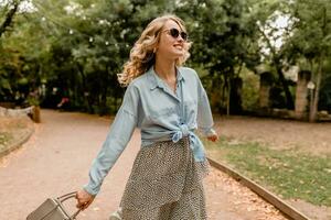 stylish blond woman walking in street park summer fashion photo