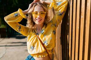 attractive blond stylish smiling woman in yellow blouse photo