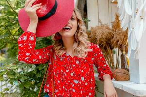 attractive stylish blond smiling woman in straw red hat and blouse summer fashion photo