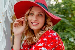 attractive stylish blond smiling woman in straw red hat and blouse summer fashion photo