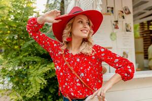 attractive stylish blond smiling woman in straw red hat and blouse summer fashion photo