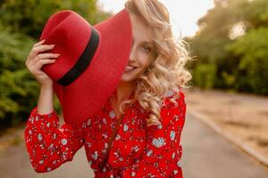 attractive stylish blond smiling woman in straw red hat and blouse summer fashion photo