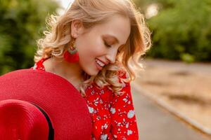 attractive stylish blond smiling woman in straw red hat and blouse summer fashion photo