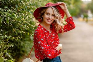 attractive stylish blond smiling woman in straw red hat and blouse summer fashion photo