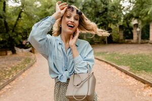 stylish blond woman walking in street park summer fashion photo