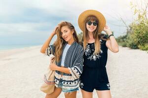 stylish beautiful women on summer vacation on tropical beach photo