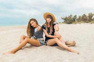 stylish beautiful women on summer vacation on tropical beach photo