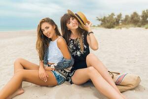 stylish beautiful women on summer vacation on tropical beach photo