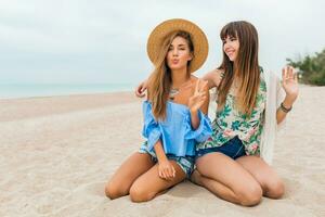 stylish beautiful women on summer vacation on tropical beach photo