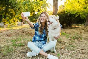 woman taking selfie photo with dog