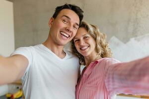 young couple having fun on bed in morning photo