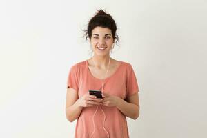 portrait of young natural looking smiling happy hipster pretty woman in pink shirt photo