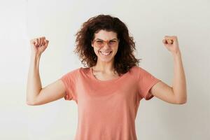 portrait of young natural looking smiling happy hipster pretty woman in pink shirt photo