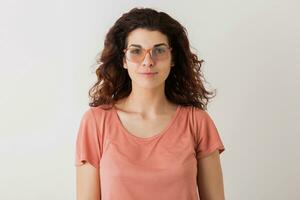 portrait of young natural looking smiling happy hipster pretty woman in pink shirt photo