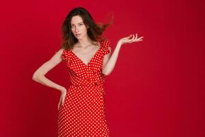 stylish woman in summer fashion trend dress on red background photo