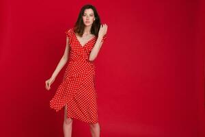 stylish woman in summer fashion trend dress on red background photo