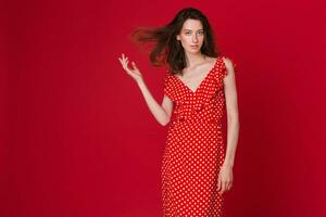 stylish woman in summer fashion trend dress on red background photo