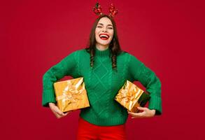 attractive woman celebrating Christmas on red background photo