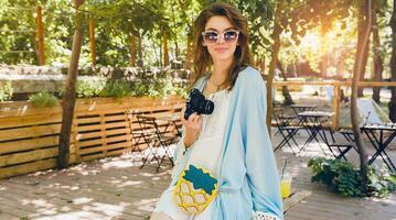 young attractive stylish woman in park photo