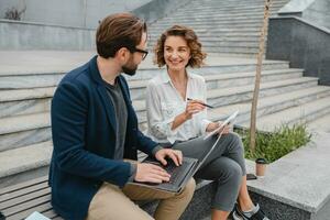 man and woman business partners working together photo