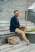 handsome busy bearded man working in park photo