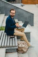 handsome busy bearded man working in park photo