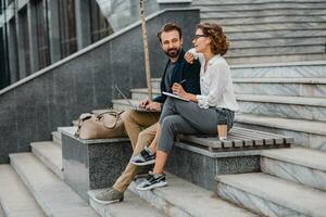 man and woman working together in park photo