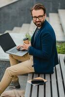 handsome busy bearded man working in park photo