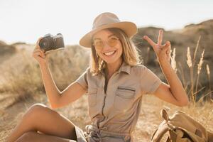 woman in desert walking on safari photo