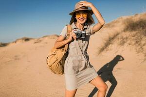 woman in desert walking on safari photo