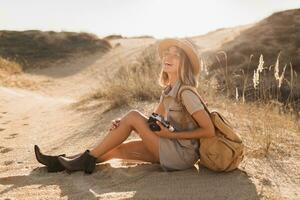 woman in desert walking on safari photo