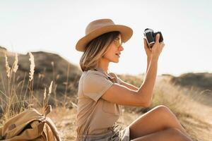 woman in desert walking on safari photo