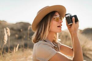 woman in desert walking on safari photo