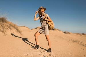 woman in desert walking on safari photo