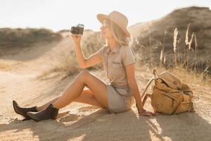 woman in desert walking on safari photo