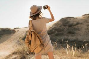 woman in desert walking on safari photo