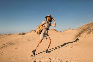 woman in desert walking on safari photo