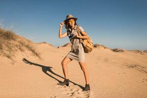 woman in desert walking on safari photo