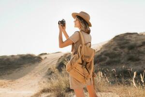 woman in desert walking on safari photo