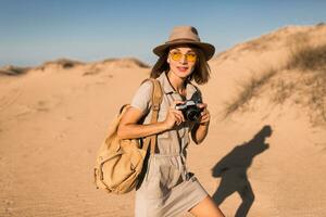 woman in desert walking on safari photo