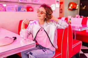 stylish smiling woman in retro vintage cafe photo