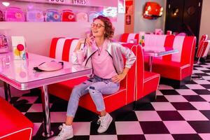 stylish smiling woman in retro vintage cafe photo