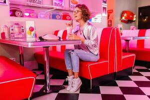 stylish smiling woman in retro vintage cafe photo