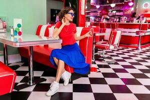 stylish smiling woman in retro vintage cafe photo